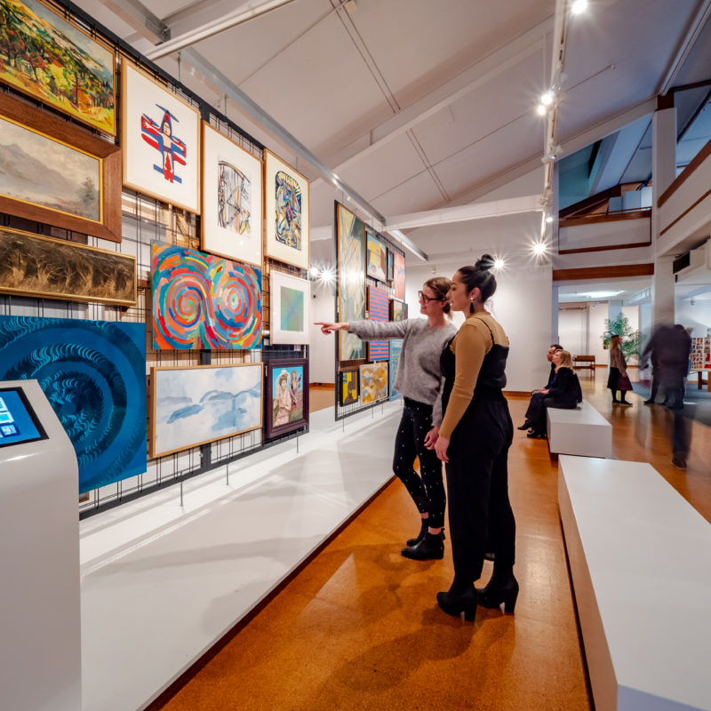 Two women view public artworks on display at Te Manawa