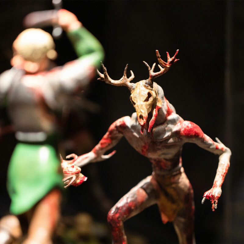 Two model figurines confront each other