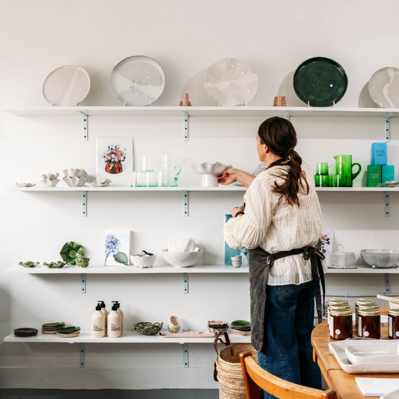 Handmade ceramics by Fiona Odering displayed on shelves inside the Mabel Vickers studio in Palmerston North